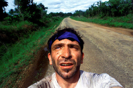 FILE PHOTO: Yannis Behrakis takes a self portrait after surviving an ambush by Revolutionary United Front rebels in the jungle of Sierra Leone when Kurt Schork and Miguel Moreno were killed, May 2000. REUTERS/Yannis Behrakis/File photo