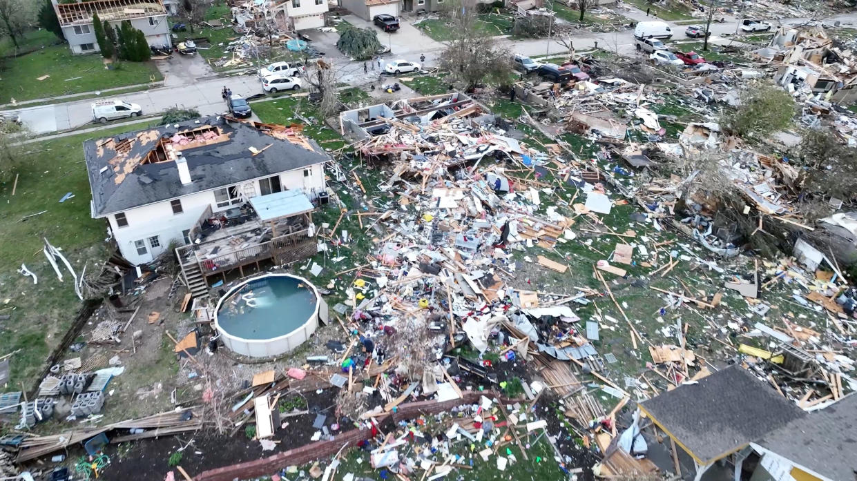 A drone view shows people inspecting the site of damaged buildings in the aftermath of a tornado in Omaha on Friday. 