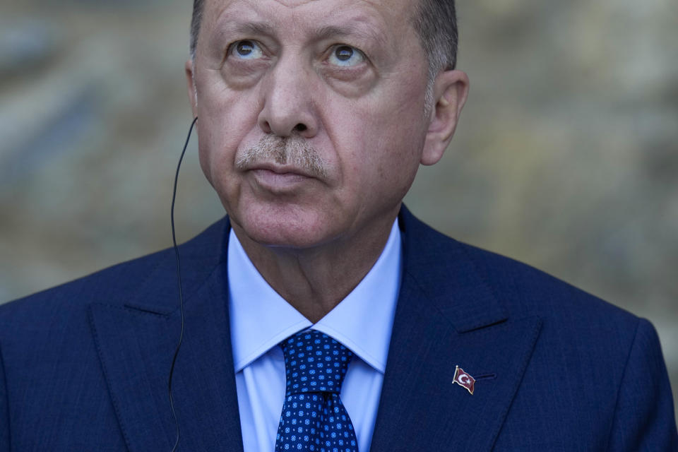 Turkey's President Recep Tayyip Erdogan looks up during a joint news conference with German Chancellor Angela Merkel following their meeting at Huber Villa presidential palace, in Istanbul, Turkey, Saturday, Oct. 16, 2021. The leaders discussed Ankara's relationship with Germany and the European Union as well as regional issues including Syria and Afghanistan. (AP Photo/Francisco Seco)