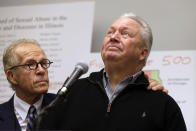 Joe Iacono, right, pauses as he comforted by attorney Jeff Anderson during a news conference, Wednesday, March 20, 2019, in Chicago. Advocates for clergy abuse victims say their list of 395 priests or lay people in Illinois who have been publicly accused of sexually abusing children is far more extensive than the names already released by the state's six dioceses. (AP Photo/Kiichiro Sato)