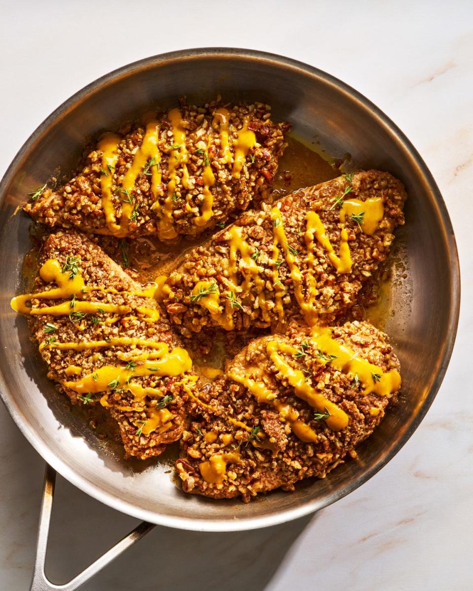 chicken cutlets are tossed in a punchy and herby maple mustard sauce, then topped with chopped pecans and baked to juicy, crunchy perfection