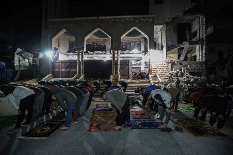 Palestinian citizens perform Tarawih prayers on the first day of the holy month of Ramadan on the rubble of Al-Huda Mosque, which was partially destroyed by Israeli air strikes on March 11, 2024 in Rafah, Gaza. The United States and other nations mediating Israel-Hamas ceasefire talks had hoped to reach a temporary truce prior to the start of the Islamic holy month, but recent meetings in Cairo did not produce a result. Meanwhile, the humanitarian situation remains dire in Gaza, with foreign nations proposing new ways to increase aid deliveries, such as the creation of a temporary port.