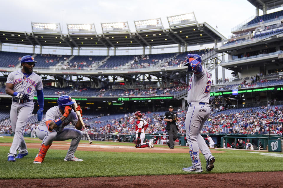 New York Mets designated hitter Pete Alonso, right, celebrates his two-run homer with Starling Marte, left, and Dominic Smith during the first inning of a baseball game against the Washington Nationals at Nationals Park, Wednesday, May 11, 2022, in Washington. (AP Photo/Alex Brandon)