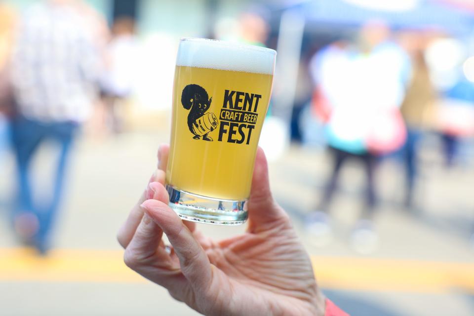 An attendee of the the Kent Jaycees Craft Beer Fest on Saturday holds her commemorative tasting glass.