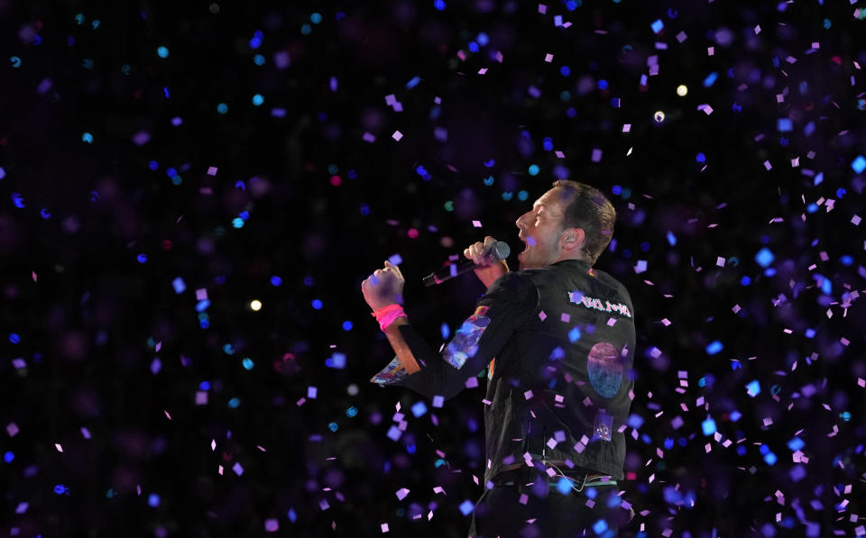 Chris Martin of Coldplay performs amidst confetti during the band's performance at the Rose Bowl, Saturday, Sept. 30, 2023, in Pasadena, Calif. (AP Photo/Chris Pizzello)
