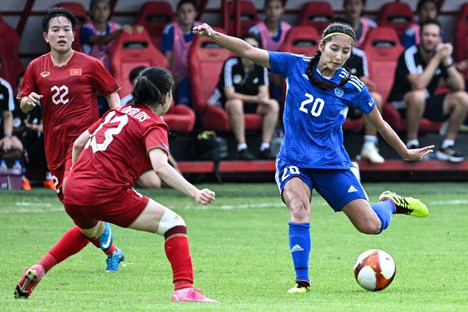 Phillipines' Quinley Quezada (R) passes the ball during the women's football match between Vietnam and Philippines at RSN Stadium during the 32nd Southeast Asian Games (SEA Games) in Phnom Penh on May 9, 2023. (Photo by NHAC NGUYEN / AFP) (Photo by NHAC NGUYEN/AFP via Getty Images)