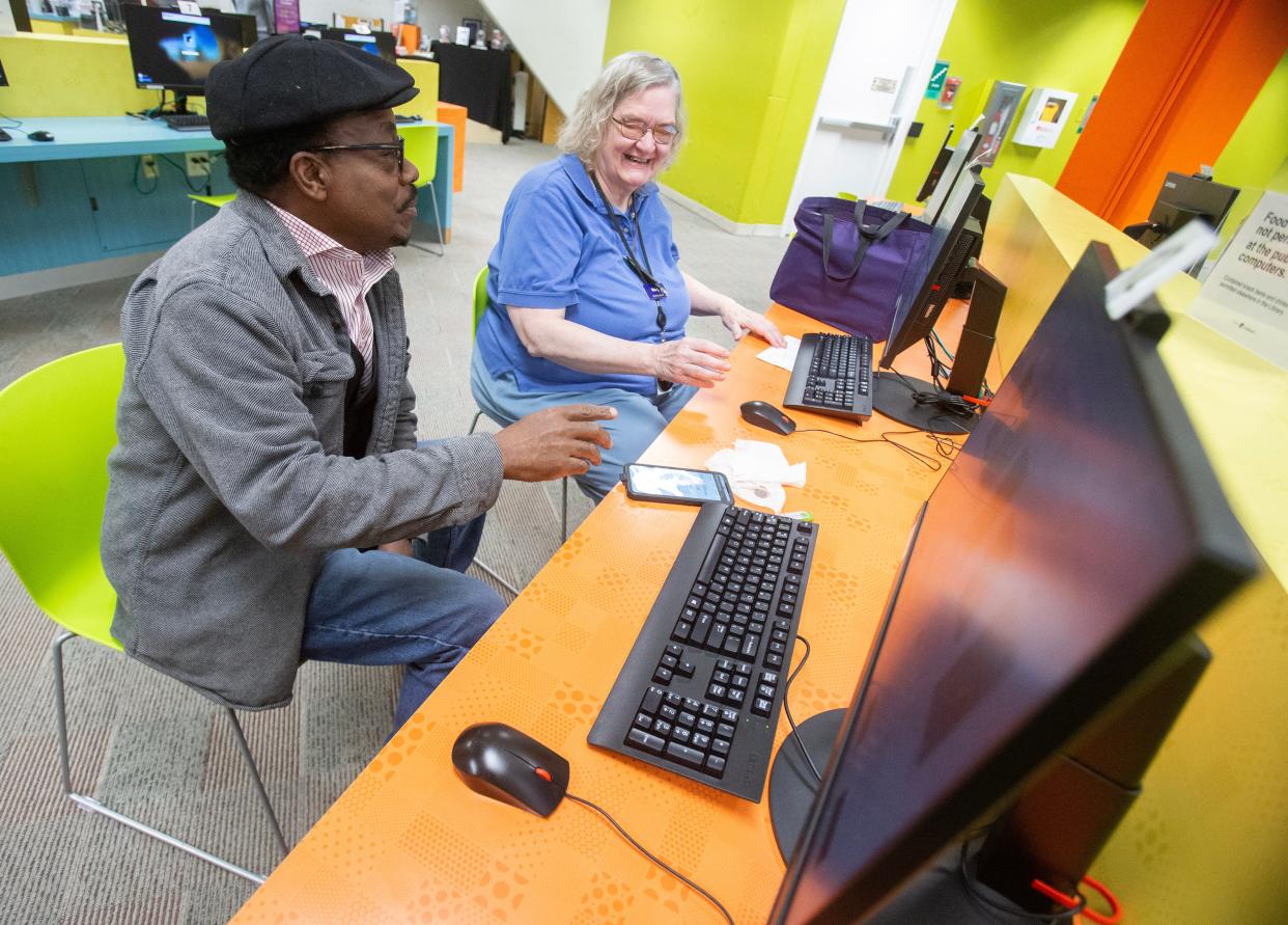 Library patron Toni Pugh works with Stark Library associate Mary Frerking on a book project in downtown Canton. The Stark Library is planning to construct a new 70,000-square-foot Main Library.