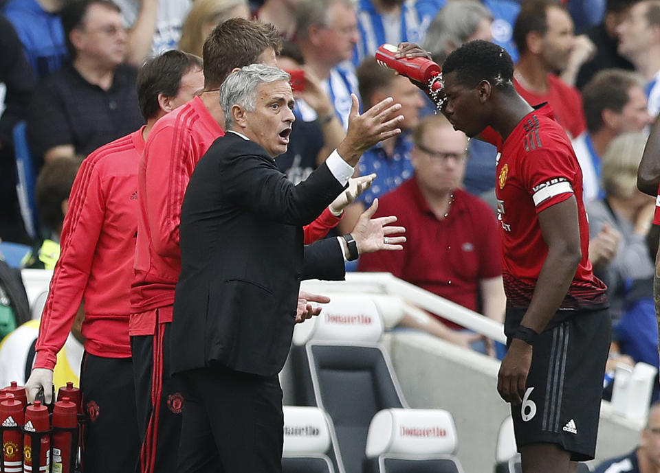 Manchester United's manager Jose Mourinho gestures as he speaks to Paul Pogba during the English Premier League soccer match between Brighton and Hove Albion and Manchester United at the Amex stadium in Brighton, England, Sunday, Aug. 19, 2018. (AP Photo/Alastair Grant)