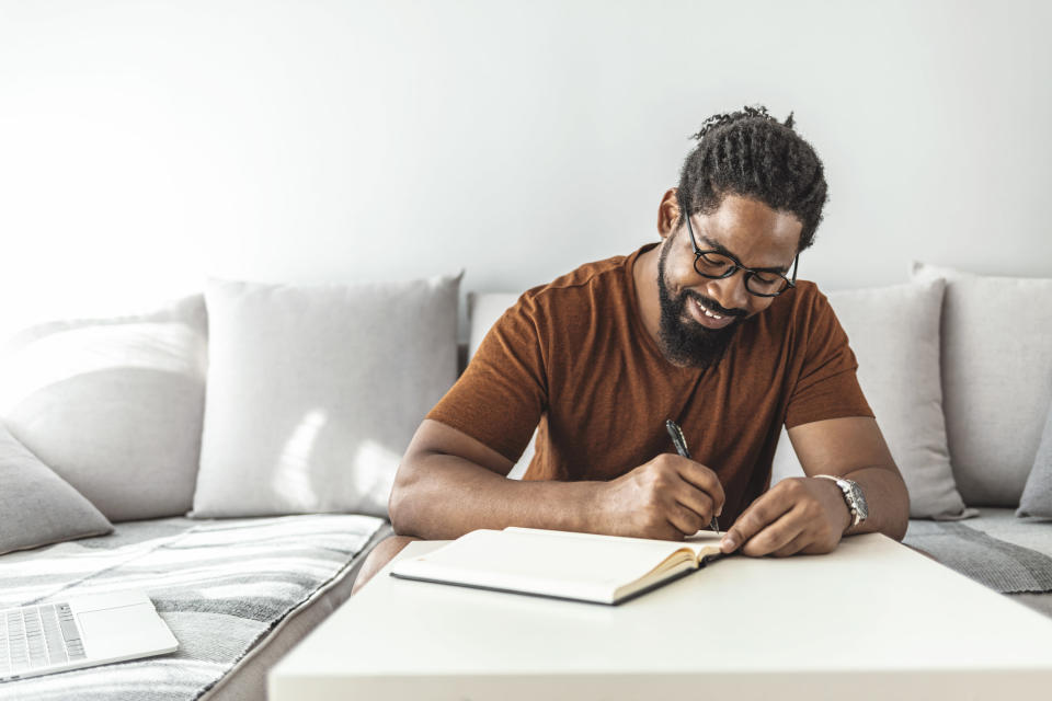 a man writing in planner