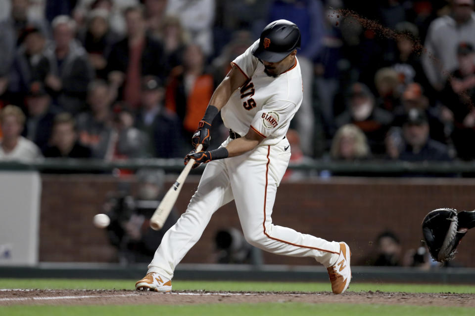 San Francisco Giants' LaMonte Wade Jr. hits a game winning single against the Arizona Diamondbacks during the ninth inning of a baseball game in San Francisco, Thursday, Sept. 30, 2021. (AP Photo/Jed Jacobsohn)