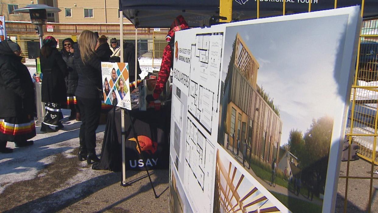 A rendering of the Urban Society for Aboriginal Youth's new youth centre sits on display at a groundbreaking ceremony in Calgary on Monday.  (Colleen Underwood/CBC - image credit)