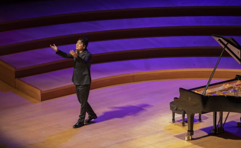 LOS ANGELES, CA - APRIL 03: Pianist Lang Lang greets the crowd as he takes the stage at Walt Disney Concert Hall on Sunday, April 3, 2022. His performance was Bach's "Goldberg Variations, BWV 988." (Myung J. Chun / Los Angeles Times)