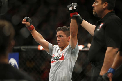 Joseph Benavidez celebrates after defeating John Moraga at UFC 187. (AP)