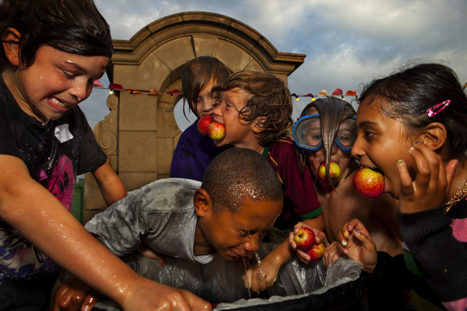 Kids bob for apples during an autumn weekend celebration in the UK. Experts say that the activity may need to be retired. (Photo by In Pictures Ltd./Corbis via Getty Images)