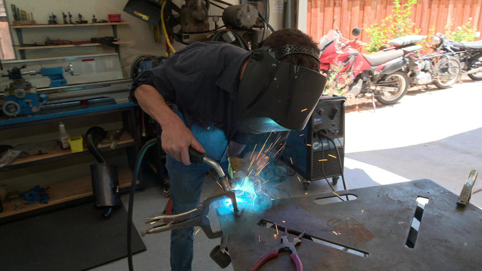 Matthew Crawford quit his position as director of a think tank, to open a motorcycle repair shop. / Credit: CBS News