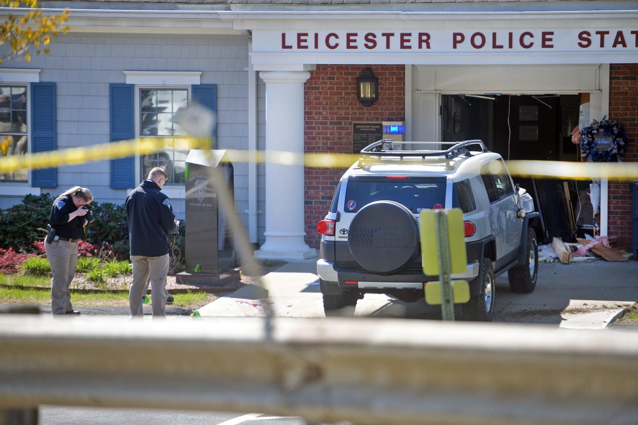 Crime scene investigators at the Leicester police station after a man drove his SUV into the building in May. The driver was shot and killed after getting out of the vehicle with a rifle, police said.