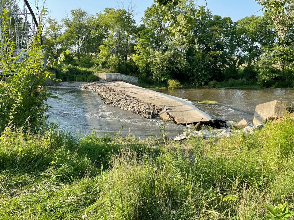 Water flows through a breach in the dam on the Maple River west of Elsie in Duplain Township on Saturday, August 19, 2023.