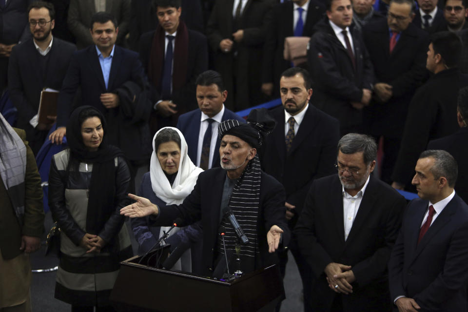 Afghanistan's President Ashraf Ghani, center, speaks to journalists after registering as a candidate for the presidential election at the Independent Elections Commission, in Kabul, Afghanistan, Sunday, Jan. 20, 2019. Ghani and Chief Executive Abdullah Abdullah on Sunday registered to run for president later this year, setting up a rematch after a bitterly disputed 2014 vote led to a power-sharing agreement brokered by the United States. (AP Photo/Rahmat Gul)