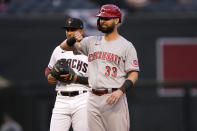Cincinnati Reds' Jesse Winker (33) gives the thumbs down after the umpires ruled his hit a double instead of a home run during the first inning of a baseball game against the Arizona Diamondbacks, Friday, April 9, 2021, in Phoenix. (AP Photo/Matt York)
