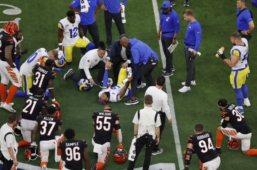 Players on both sides kneel as Rams wide receiver Odell Beckham Jr is tended to after being injured