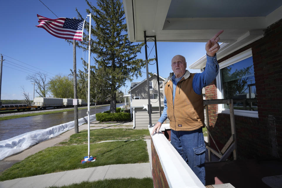 Dale O'Donnell stands on his front porch as he looks out over floodwaters from the nearby Mississippi River, Monday, May 1, 2023, in Buffalo, Iowa. (AP Photo/Charlie Neibergall)