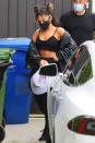 <p>Ariana Grande leaves the gym in a cropped workout set on Wednesday in Los Angeles.</p>