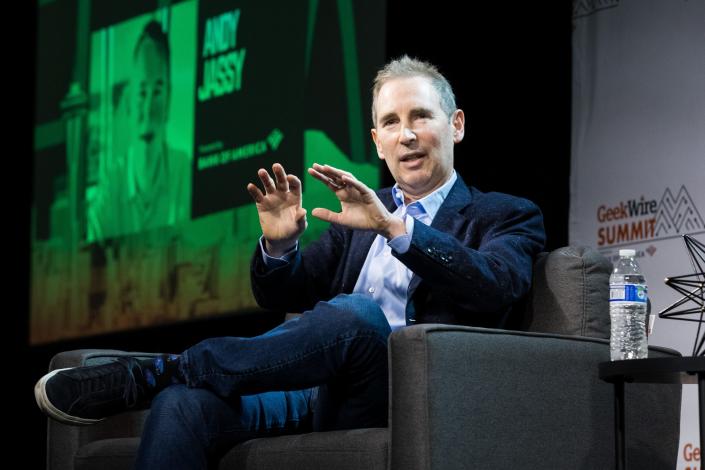 Amazon CEO Andy Jassy moves with his hands on stage at the GeekWire Summit.