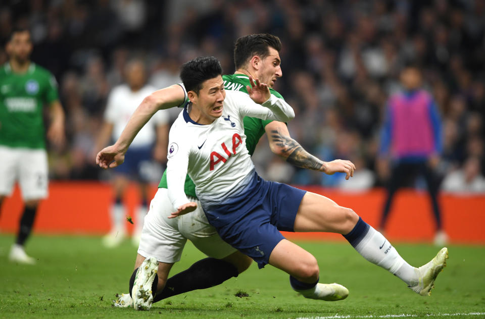  Heung-Min Son of Tottenham Hotspur is challenged by Lewis Dunk of Brighton and Hove Albion during the Premier League match between Tottenham Hotspur and Brighton & Hove Albion