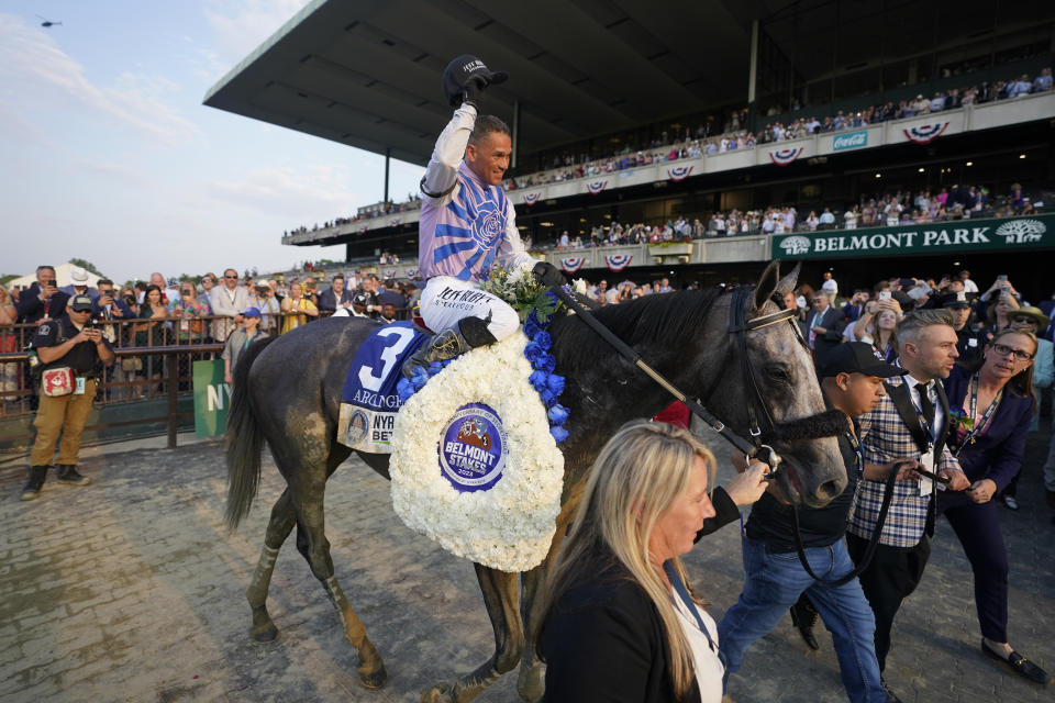 Jockey Javier Castellano, atop Arcangelo, celebrates as trainer Jena Antonucci, far right, leads them to the winners circle after winning the 155th running of the Belmont Stakes horse race, Saturday, June 10, 2023, at Belmont Park in Elmont, N.Y. (AP Photo/John Minchillo)
