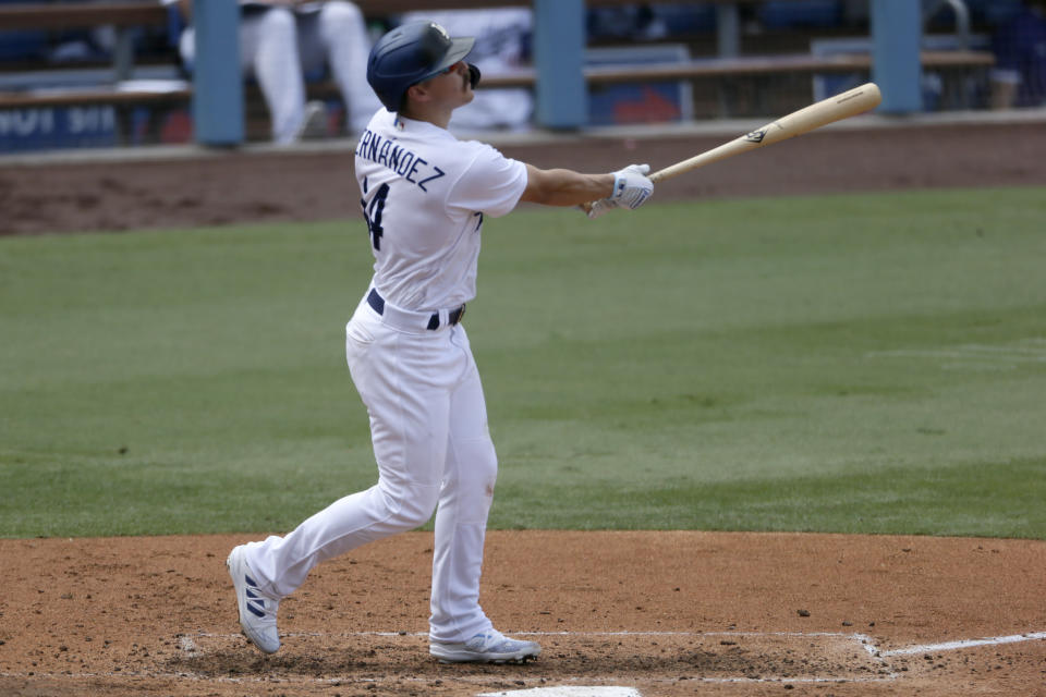 Los Angeles Dodgers' Enrique Hernandez follows through hitting a three-run home run against the Colorado Rockies during the fourth inning of a baseball game in Los Angeles, Sunday, Aug. 23, 2020. (AP Photo/Alex Gallardo)