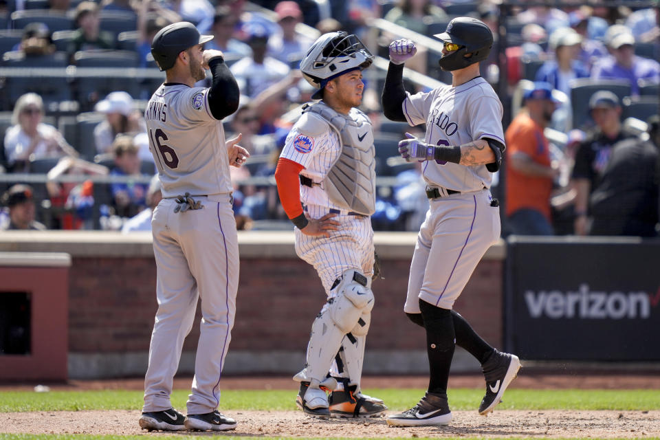 Colorado Rockies' Brenton Doyle, right, celebrates his two-run home run with Austin Wynns (16) in the fifth inning of a baseball game against the New York Mets, Sunday, May 7, 2023, in New York. (AP Photo/John Minchillo)