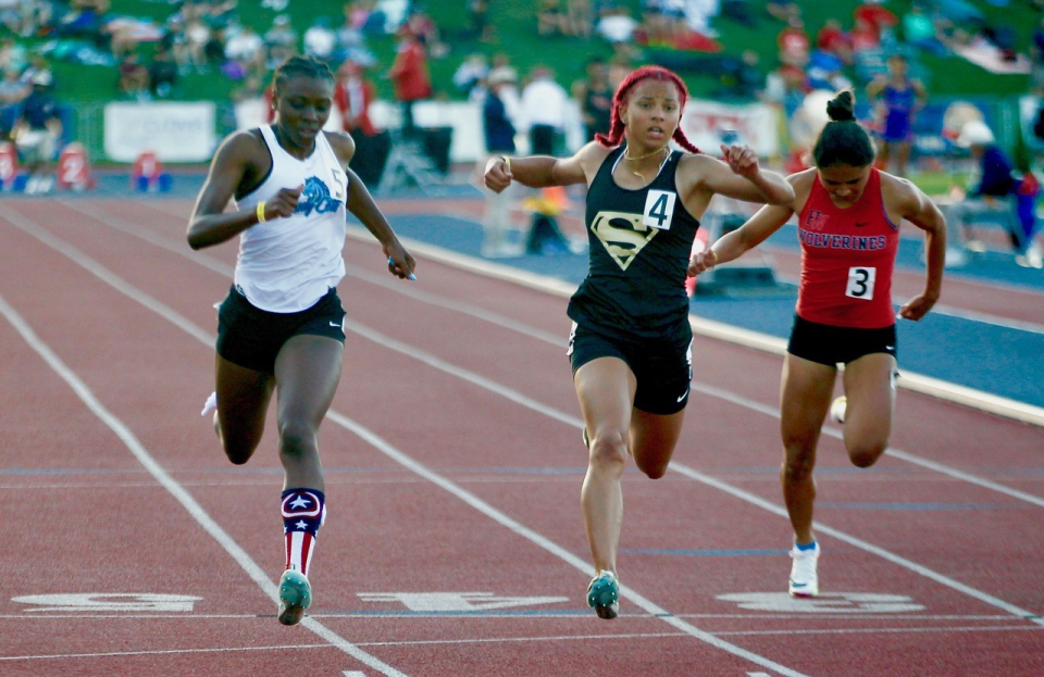 Carson junior Reign Redmond wins the girls' 100 meters by one-hundredth of a second over Serra's Brazil Neal.