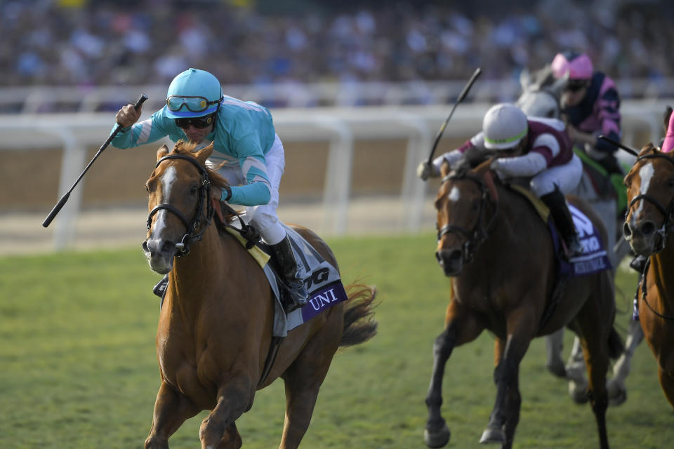 Joel Rosario, left, aboard Uni celebrates after winning the Breeders' Cup Mile horse race at Santa Anita Park, Saturday, Nov. 2, 2019, in Arcadia, Calif. (AP Photo/Mark J. Terrill)