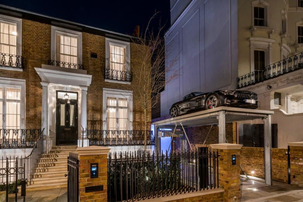 The car lift rises up from a two-storey basement (Strutt & Parker)