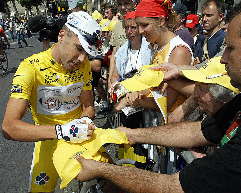 Bradley McGee signing autographs in yellow at the 2003 Tour de France