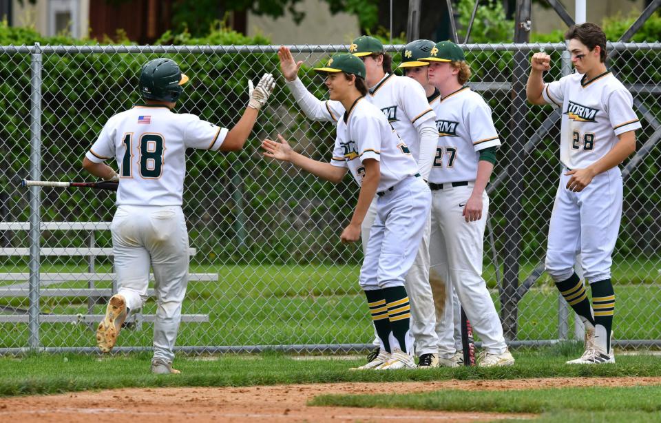 Sauk Rapids players congratulate Jeff Solorz after scoring a run during the game Tuesday, May 31, 2022, in Cold Spring.