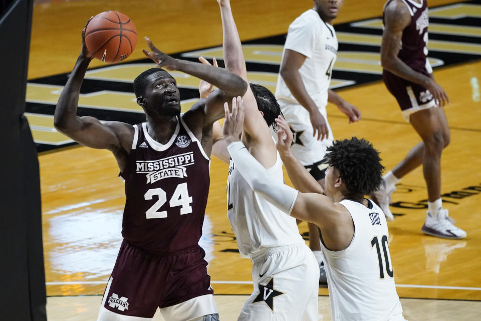 Mississippi State forward Abdul Ado (24) drives against Vanderbilt's Quentin Millora-Brown, center, and Myles Stute (10) in the second half of an NCAA college basketball game Saturday, Jan. 9, 2021, in Nashville, Tenn. (AP Photo/Mark Humphrey)