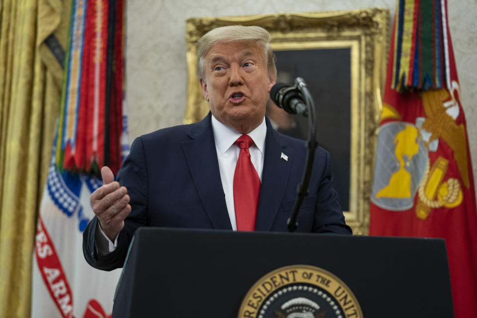 President Donald Trump speaks during a ceremony to present the Presidential Medal of Freedom to former football coach Lou Holtz, in the Oval Office of the White House, Thursday, Dec. 3, 2020, in Washington. (AP Photo/Evan Vucci)