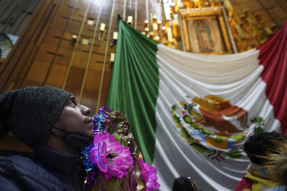 A pilgrim looks up at the image of Our Lady of Guadalupe inside the Basilica of Guadalupe on her feast day in Mexico City, early Tuesday, Dec. 12, 2023. Devotees of Our Lady of Guadalupe gather for one of the world's largest religious pilgrimages on the anniversary of one of several apparitions of the Virgin Mary witnessed by an Indigenous Mexican man named Juan Diego in 1531. (AP Photo/Marco Ugarte)