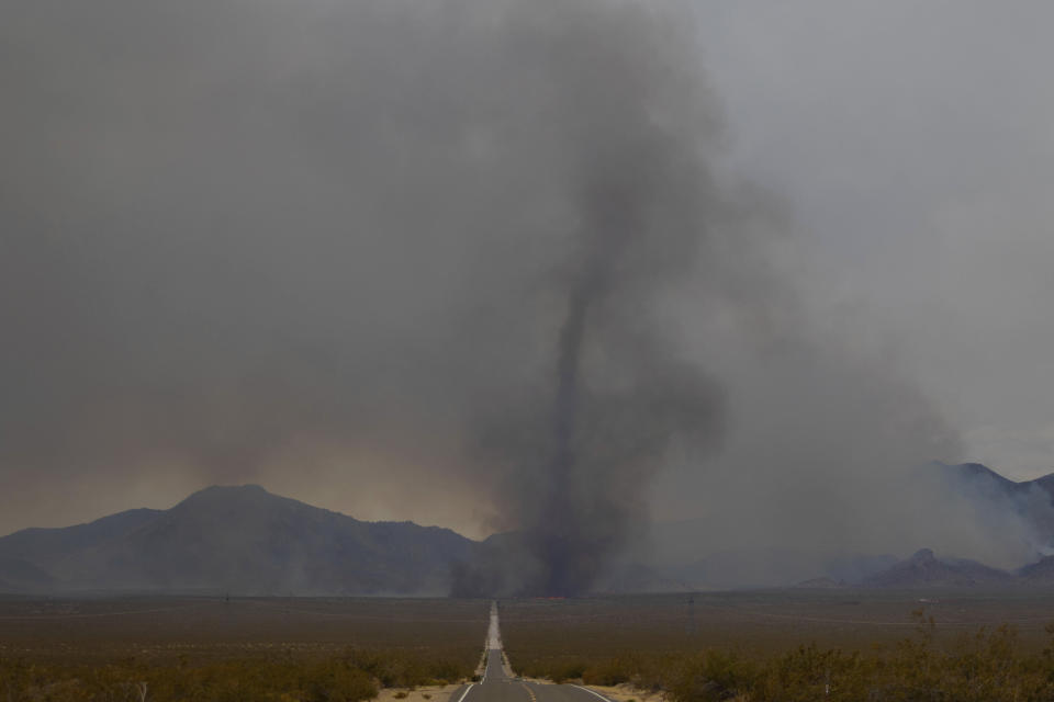 A vortex of ash rises from the York Fire on Sunday, July 30, 2023, in the Mojave National Preserve, Calif. Crews battled “fire whirls” in California’s Mojave National Preserve this weekend as a massive wildfire crossed into Nevada amid dangerously high temperatures and raging winds. (AP Photo/Ty O'Neil)