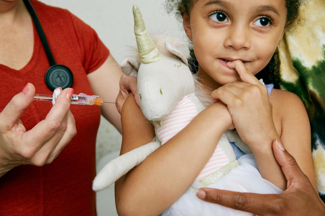 Stock photo of child receiving a vaccine.