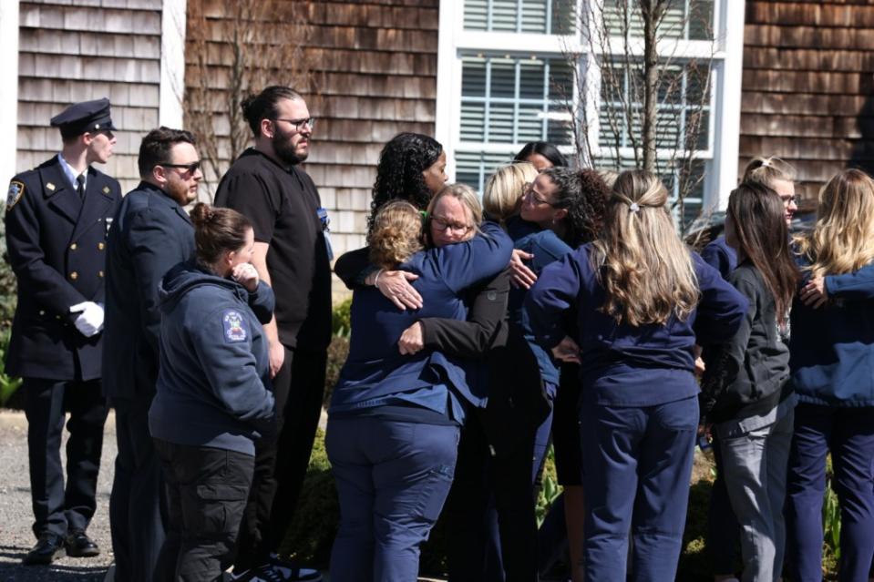 A group of mourners hug as they attend the wake on Friday. Dennis A. Clark for NY Post