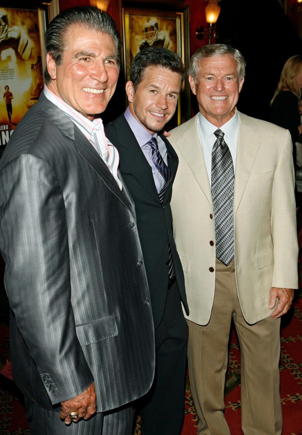 From left, Vince Papale, actor Mark Wahlberg and former Eagles coach Dick Vermeil, pose for photographers during red carpet arrivals at the world premiere of the film "Invincible" in 2006.