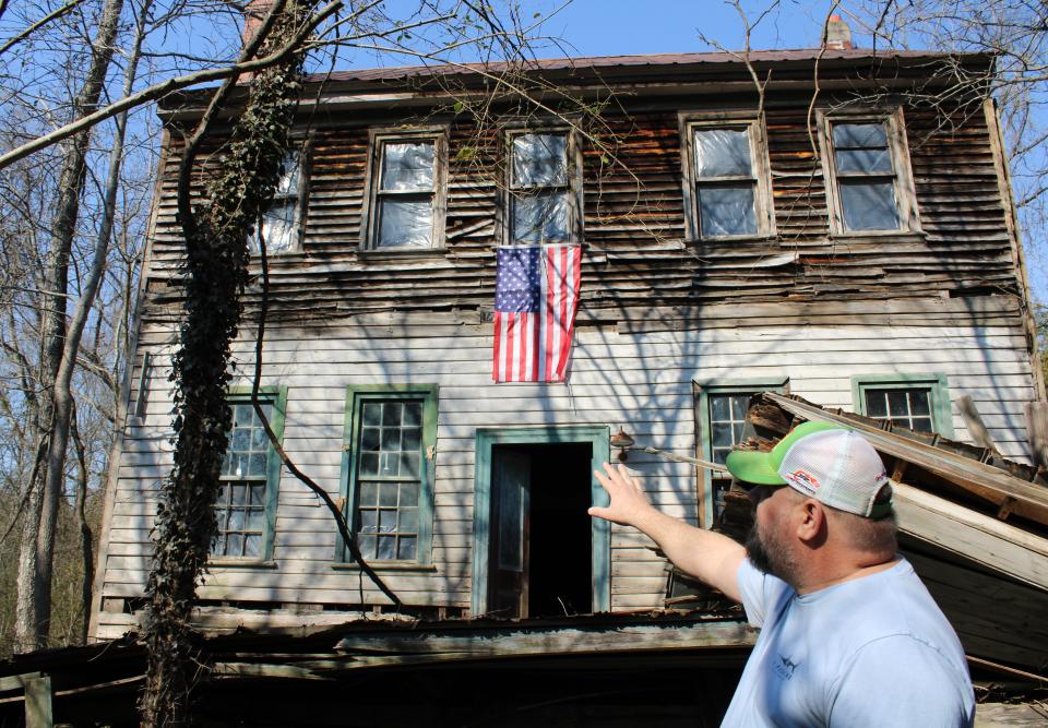 Richard "Richie" Blick points at the original 18th century weatherboard siding on his family's ancestral home in Lawrenceville, Virginia on February 22, 2024.