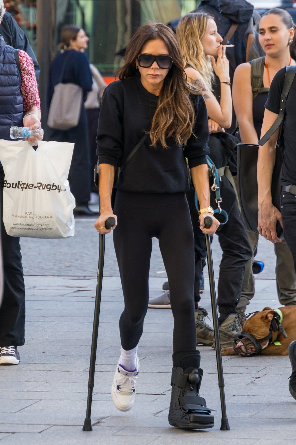 Break it like Beckham: Victoria hobbling around Paris with a foot injury (GC Images)