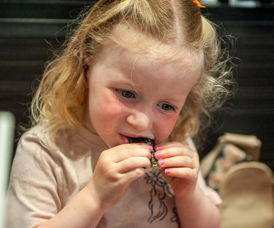 MacKenna Hibbard, 4, of Millis, enjoys sushi with her mom, Carrie, at the new Kura Revolving Sushi Bar in Shoppers World in Framingham, July 6, 2023.