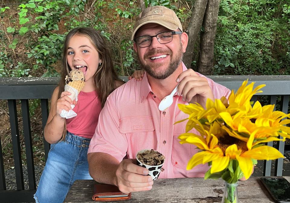 TShane Johnson and his daughter, Charli, owners of Big Guns Coffee, share some ice cream together.