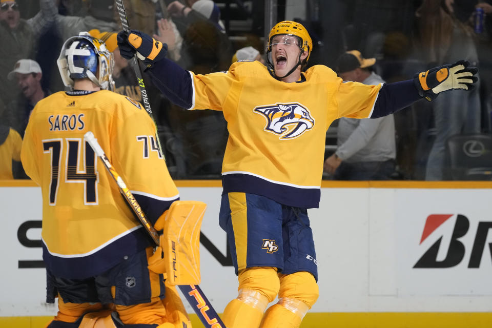 Nashville Predators' Michael McCarron, right, celebrates with goaltender Juuse Saros (74) after the Predators beat the Arizona Coyotes 4-3 in a shootout in an NHL hockey game Monday, Nov. 21, 2022, in Nashville, Tenn. (AP Photo/Mark Humphrey)