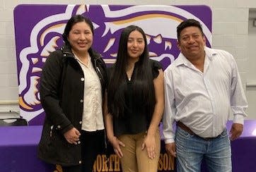 North Henderson High School student Citlally Diaz, center, poses with her parents, Yanet Mar Peralta and Esau Diaz Hernandez on Dec. 7 at North after being honored for winning Optimum's Hispanic Heritage Month Essay award.