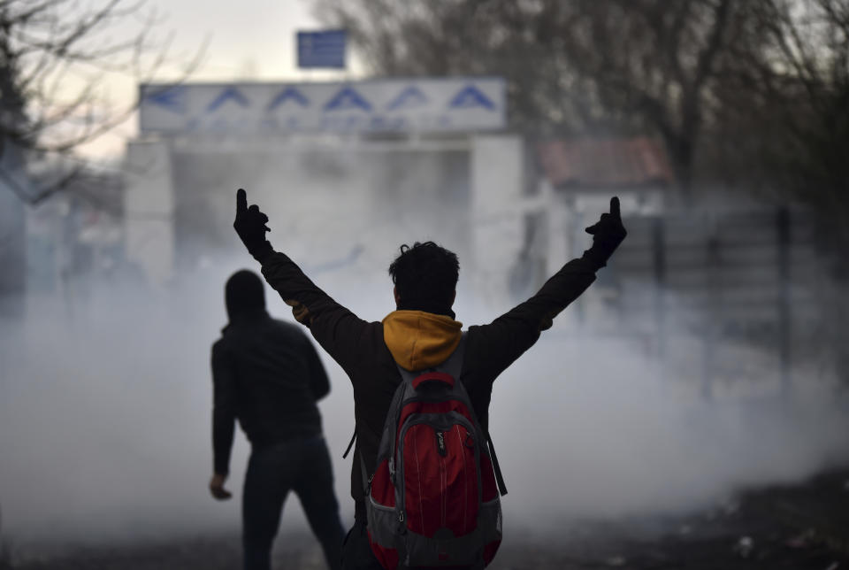 Greek border guard use teargas on migrants trying to enter Greece, at Pazarkule border gate, Edirne, Turkey, Saturday, Feb. 29, 2020. (Ismail Coskun/IHA via AP)